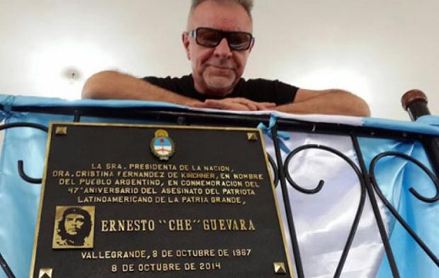 León Gieco tras la placa que recuerda el asesinato del Che Guevara en Vallegrande (Bolivia).